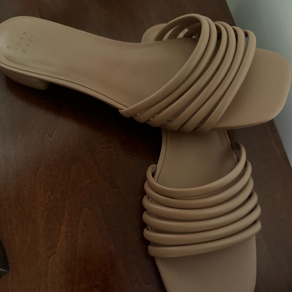 Tan faux leather band slides.